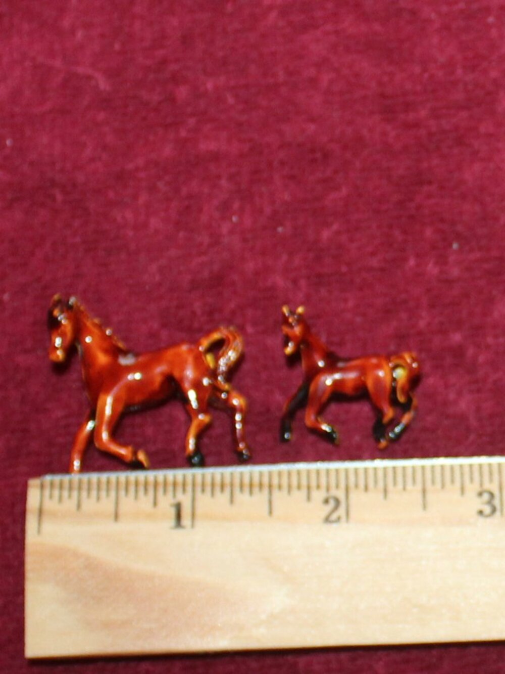 Vintage enameled metal pins featuring a brown horse and foal